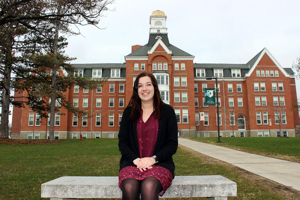 Alexa sitting on a bench behind Ball Hall