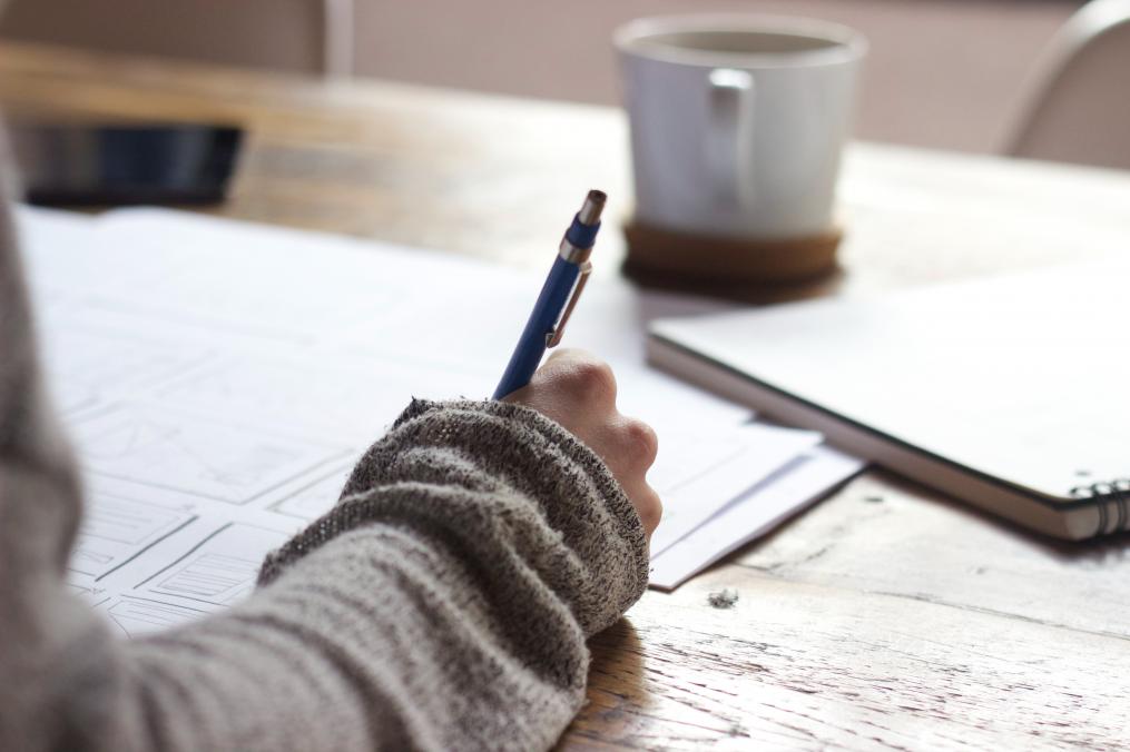 A hand holding a pen taking an exam