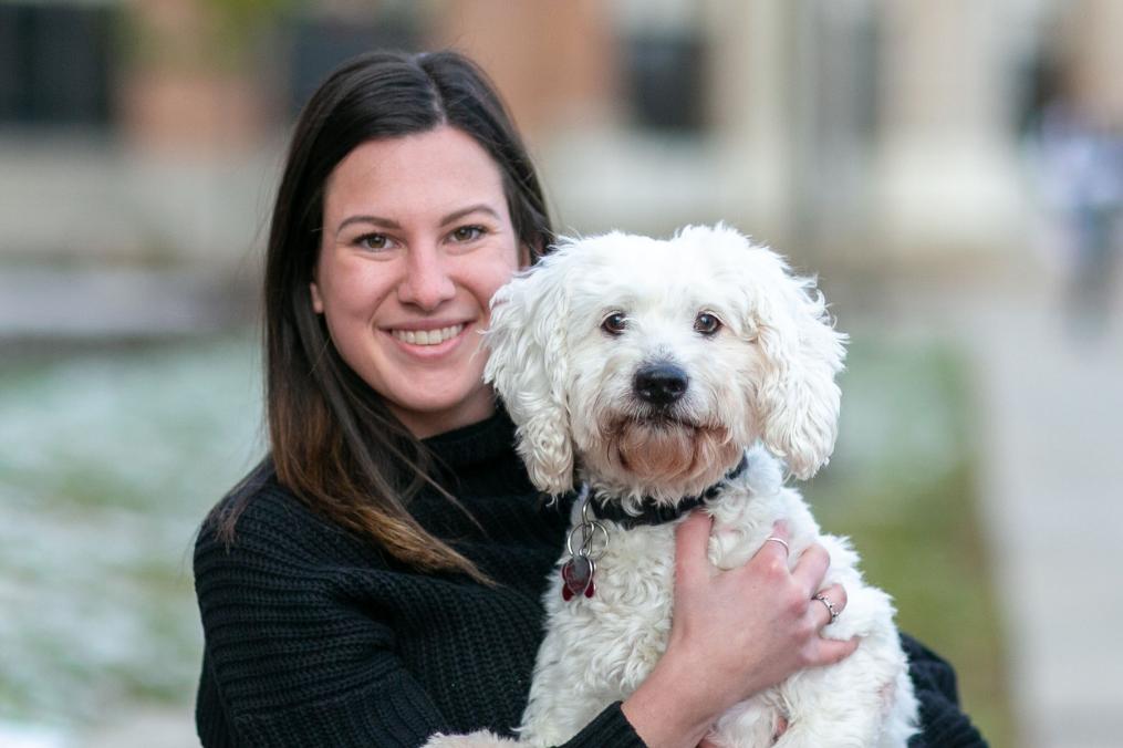 Megan Wittman, a biology degree student, poses with a cockapoo.