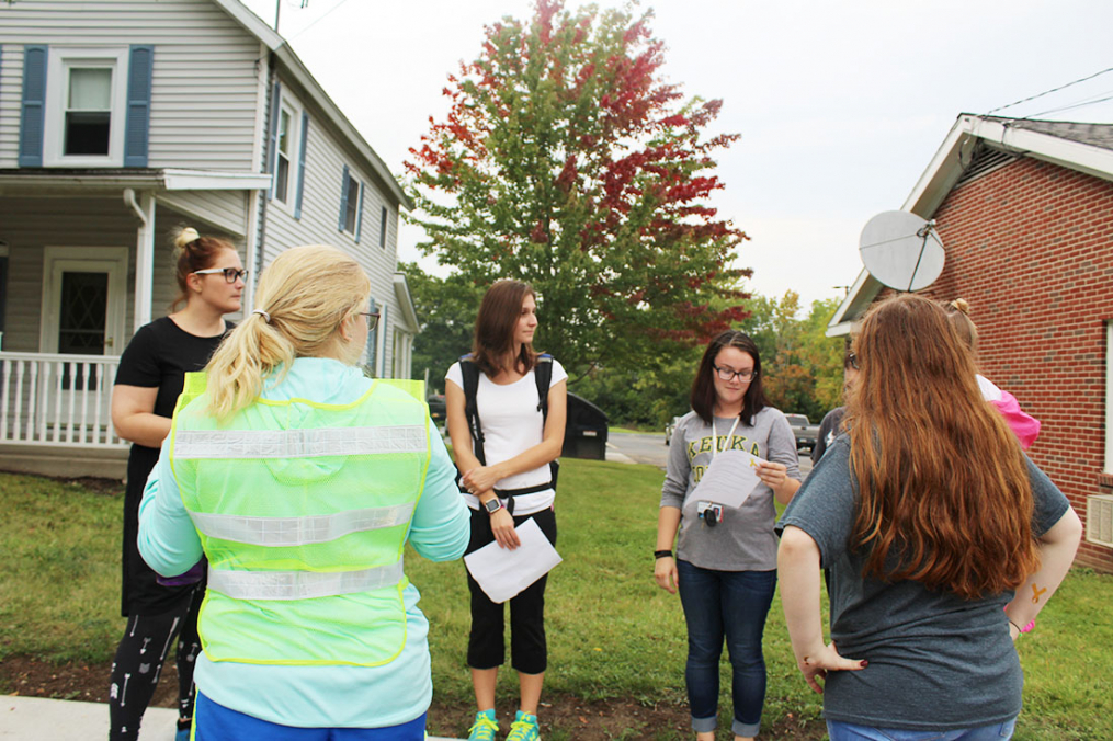 A group of students pause during the 2017 One Walk to listen to statistics about suicide.