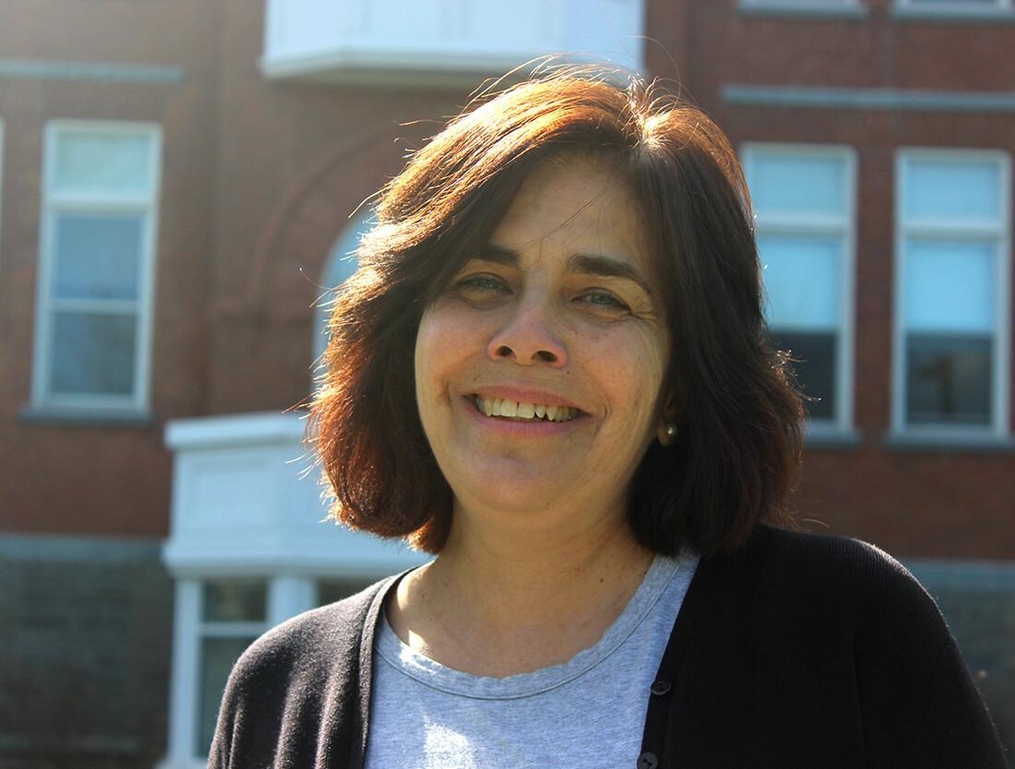 Photo of Nancy standing outside of Ball Hall