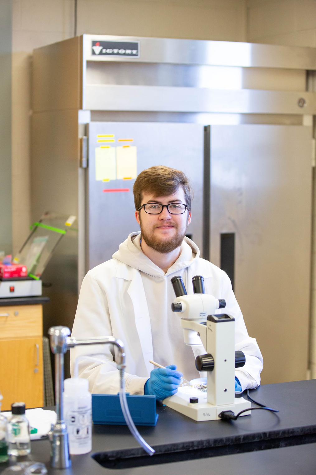 Austin Glazer smiling in biology lab 