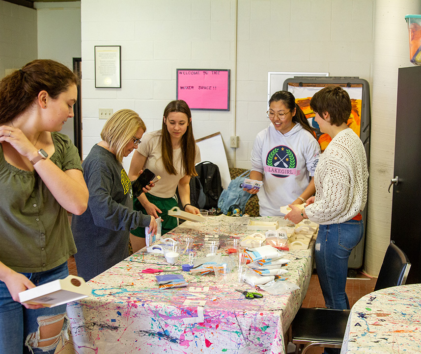 Students and faculty completing a wellness activity with paint